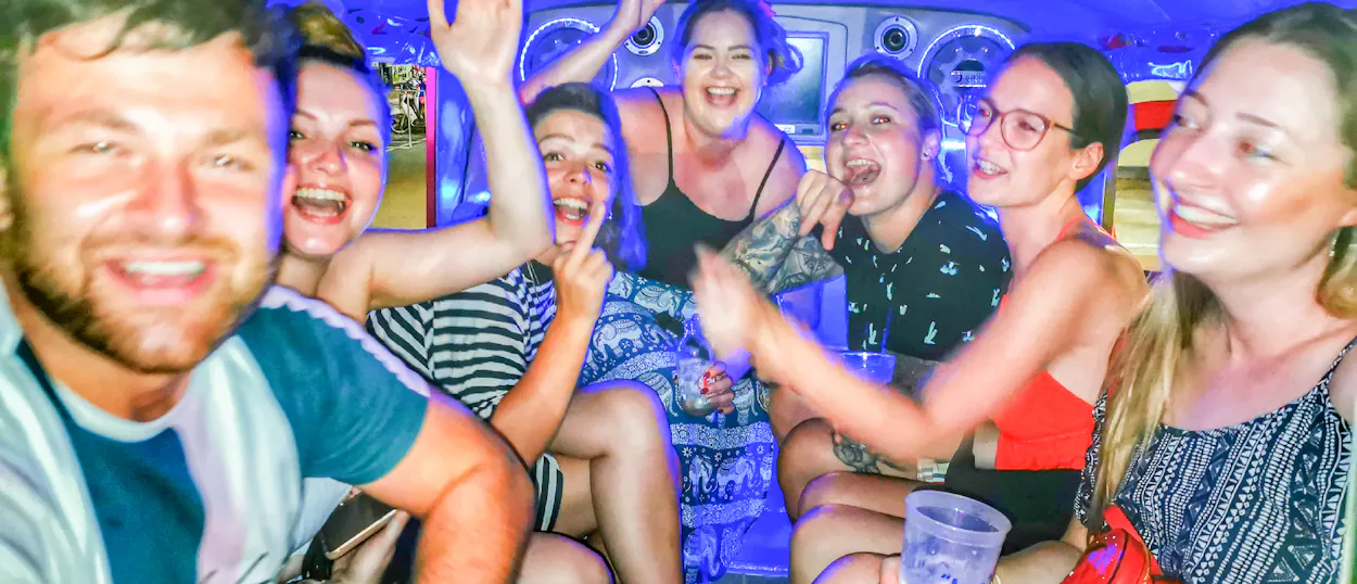Smiling backpackers enjoying the vibrant nightlife and party atmosphere in Krabi.