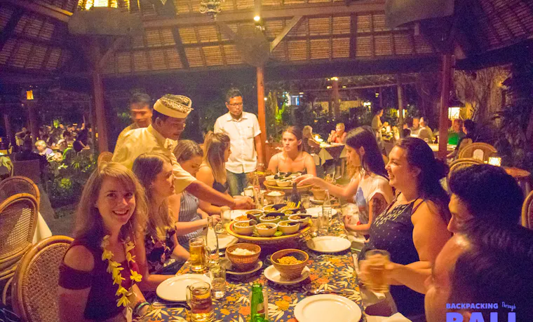 Backpacking group enjoying dinner together at a Balinese restaurant