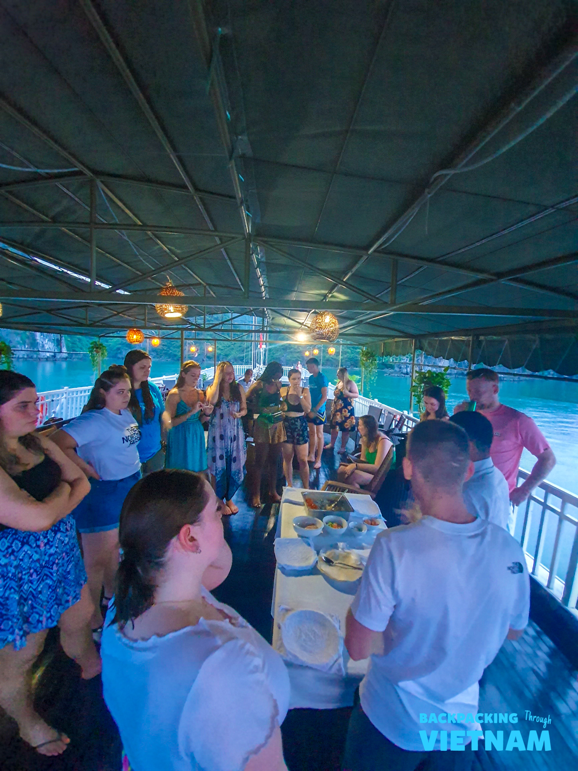Backpackers gather for a cooking lesson on a boat in Halong Bay, Vietnam.