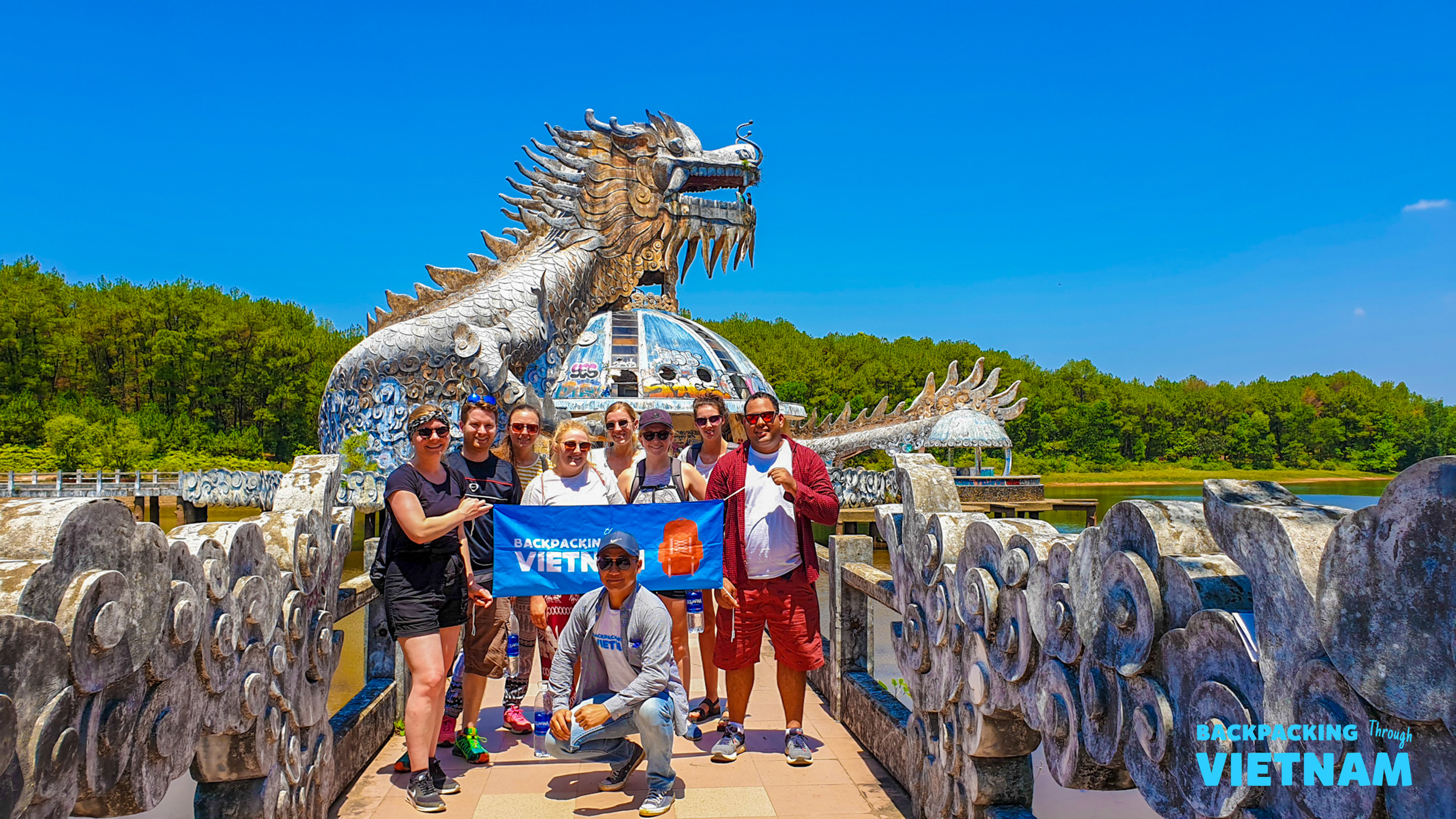Backpackers explore the fascinating abandoned dragon water park in Hue, Vietnam.