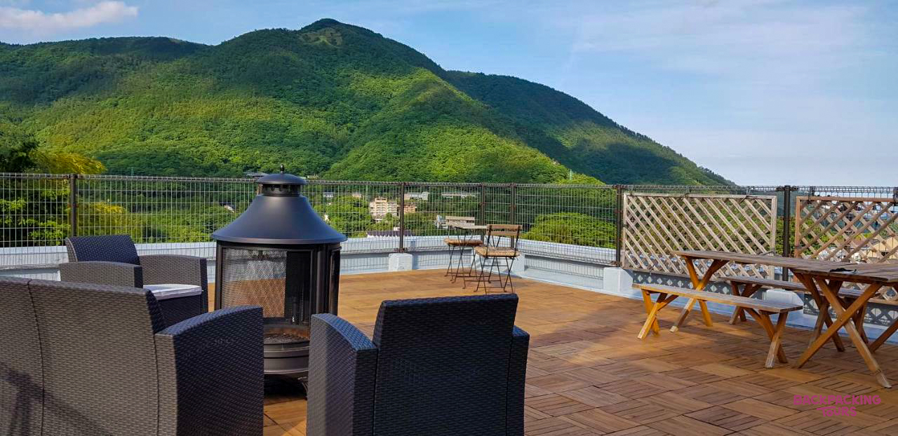 Enjoy a breathtaking sunset from this Hakone rooftop deck with a fire pit and comfortable seating.