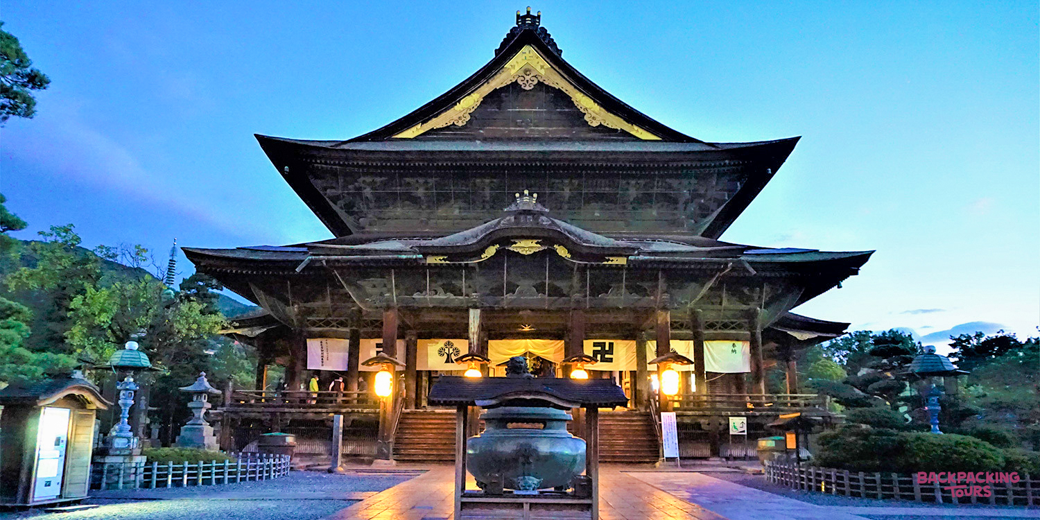 The ancient Zenkoji Temple in Takayama, beautifully illuminated at twilight, offers a serene stay.