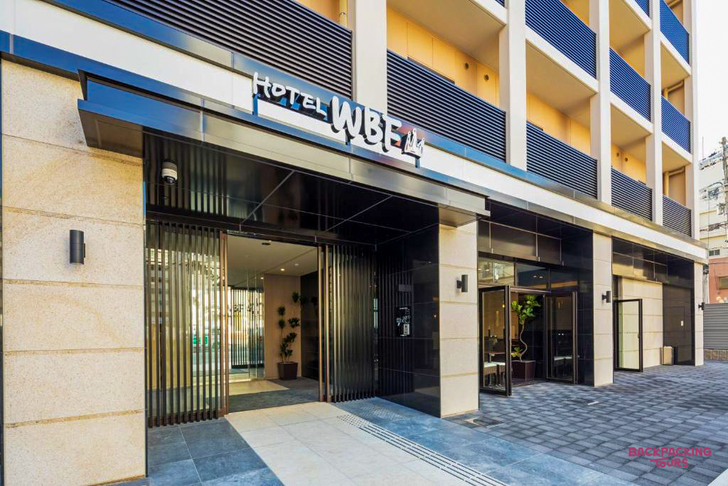 The modern exterior of Hotel WBF Namba Motomachi in Osaka, a welcoming accommodation for backpackers.