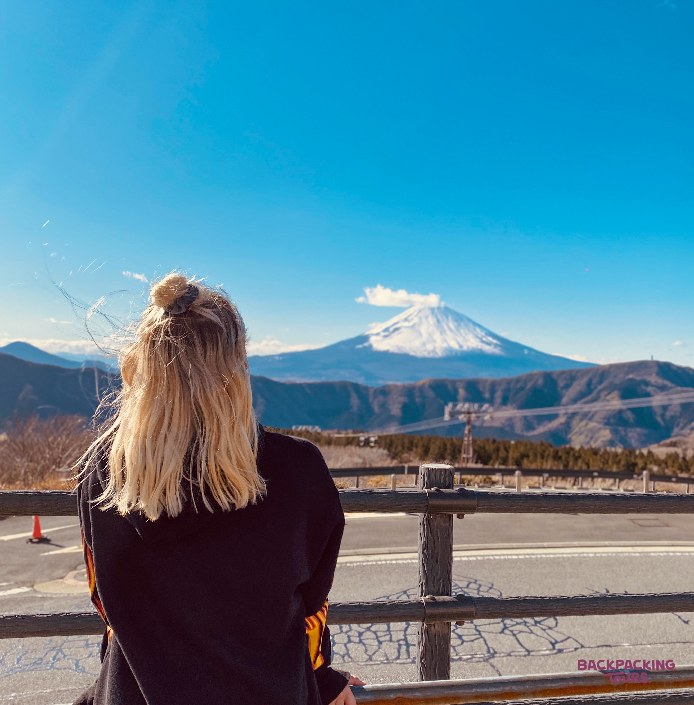 Enjoying spectacular views of the snow-capped Mount Fuji from a scenic overlook in Hakone, Japan.