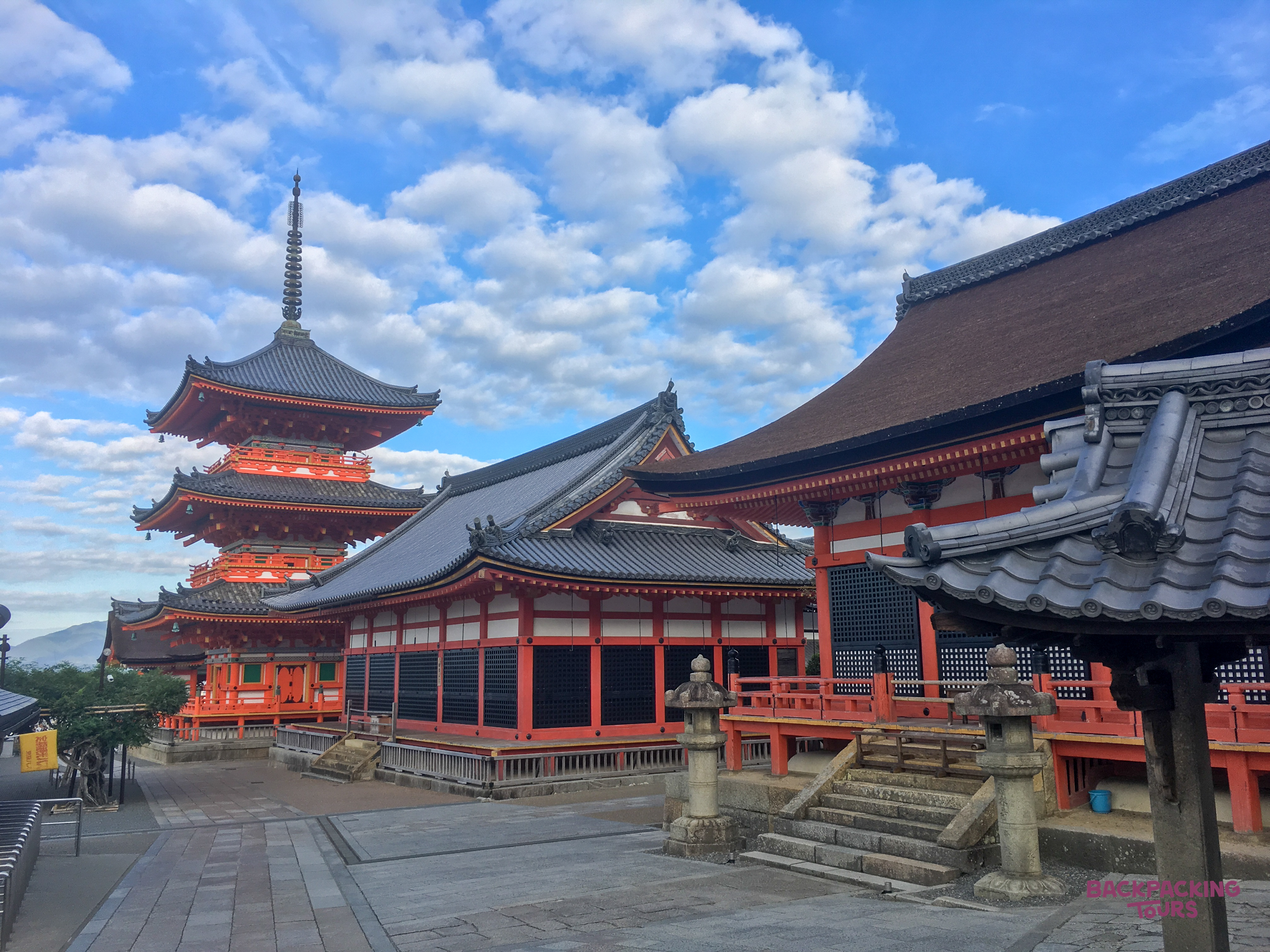 Early morning at Kiyomizu-dera temple in Kyoto, showing the vibrant pagoda and traditional temple halls.