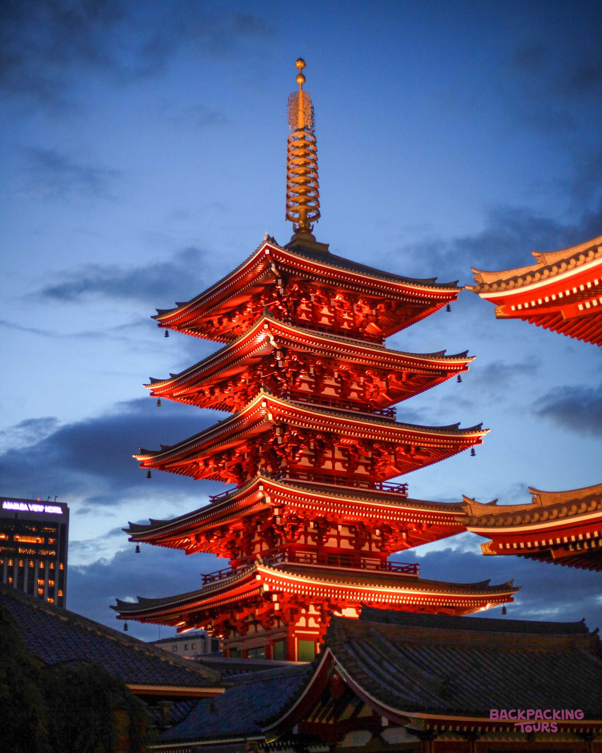 The iconic five-story pagoda of Senso-ji temple glows red at twilight in Tokyo.