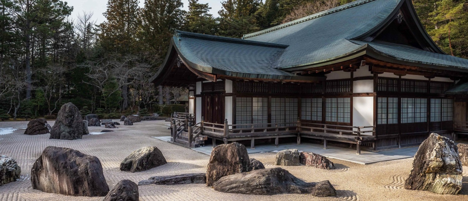 Experience tranquility at Koyasan's traditional Japanese temple, featuring a serene raked rock garden.