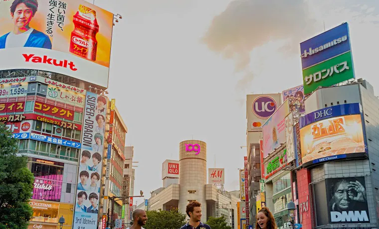 Travellers walking across the world's busiest intersection in Shibuya