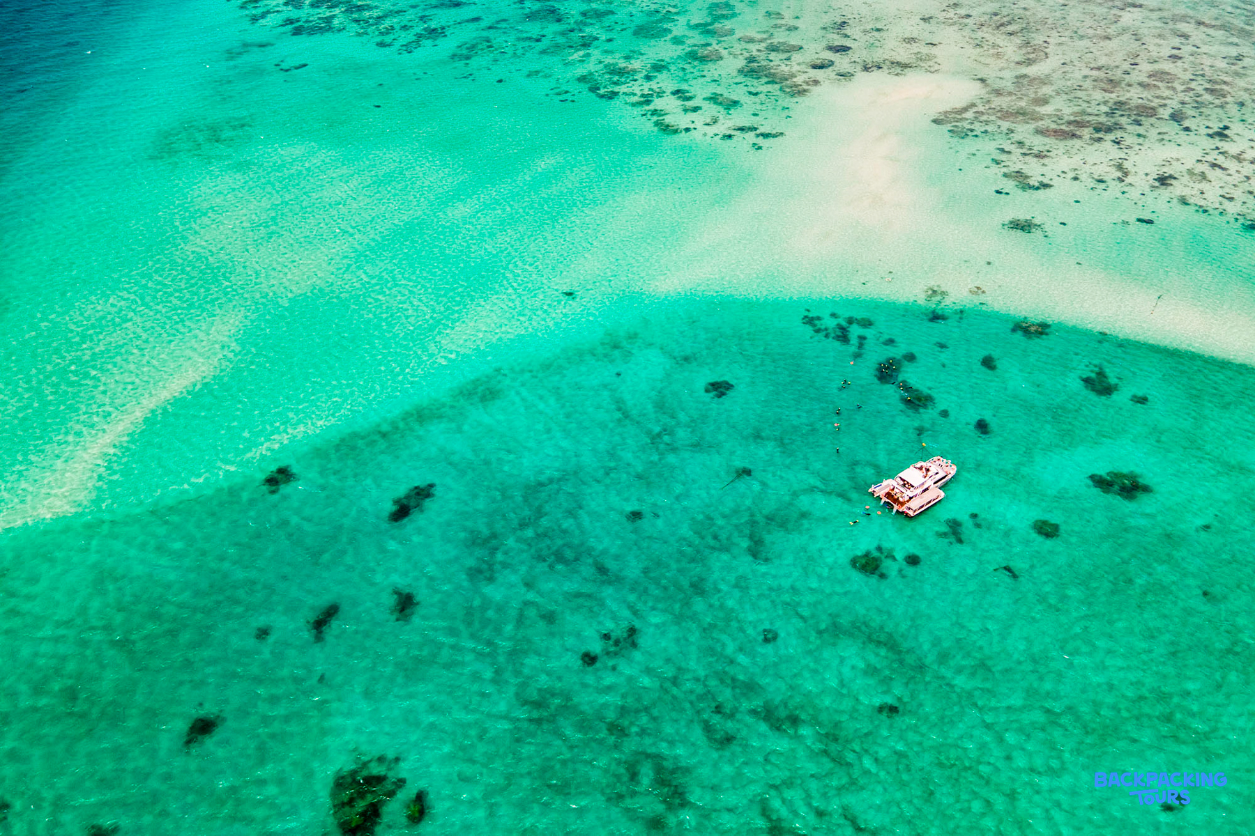 Snorkel boat anchored in the stunning turquoise waters of the Great Barrier Reef near Cairns.