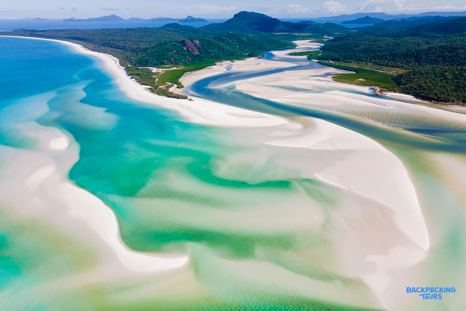 Stunning aerial view of Whitehaven Beach in the Whitsundays, featuring swirling white sand and turquoise water.