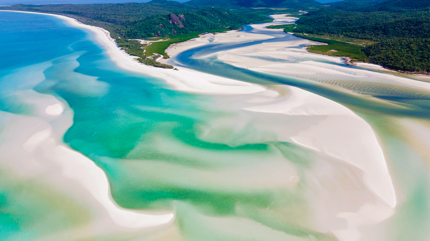 Aerial view of the stunning swirling white sands and turquoise waters at Whitsundays, Australia.