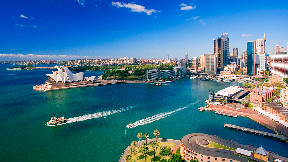 Vibrant Sydney Harbour on a sunny day, showcasing the iconic Opera House and city skyline.