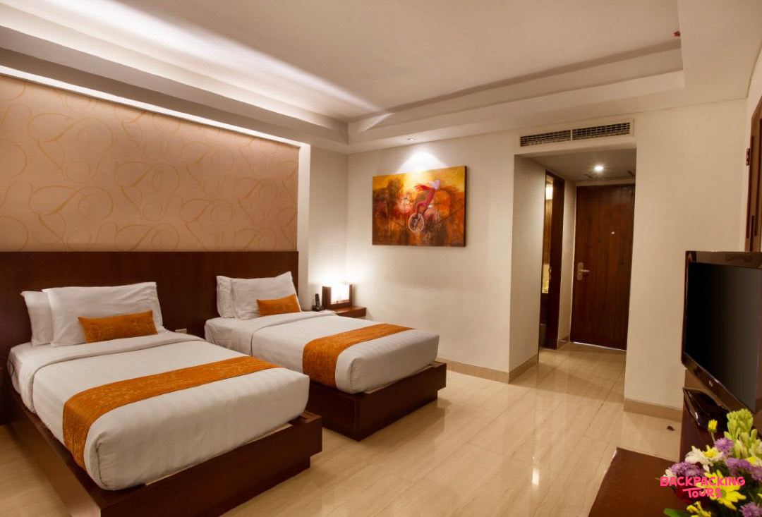 A comfortable and inviting hotel room in Seminyak, Bali, featuring two twin beds.
