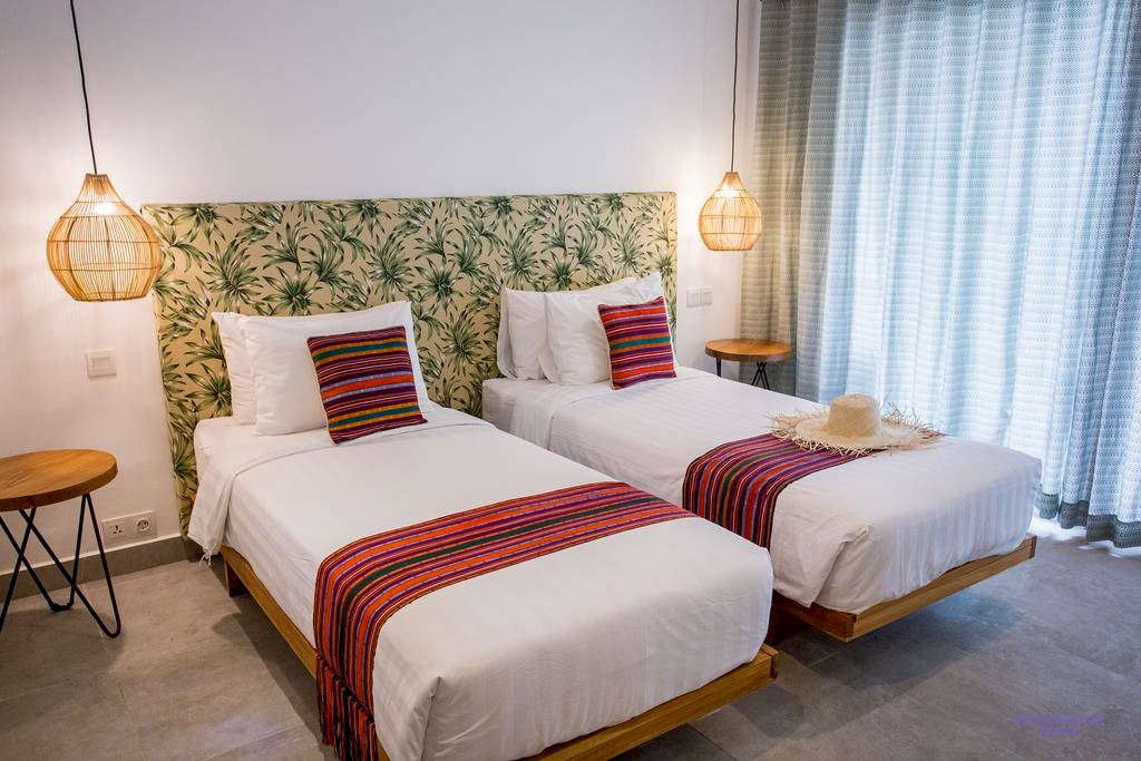 Relax in a comfortable bungalow room with twin beds and tropical decor on Gili Trawangan island.