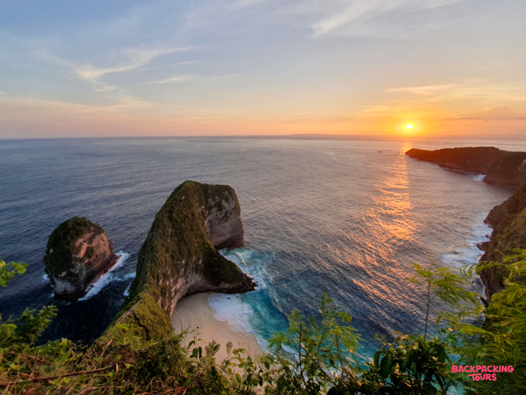 Iconic T-Rex shaped Kelingking Beach on Nusa Penida glows under a beautiful golden sunset.