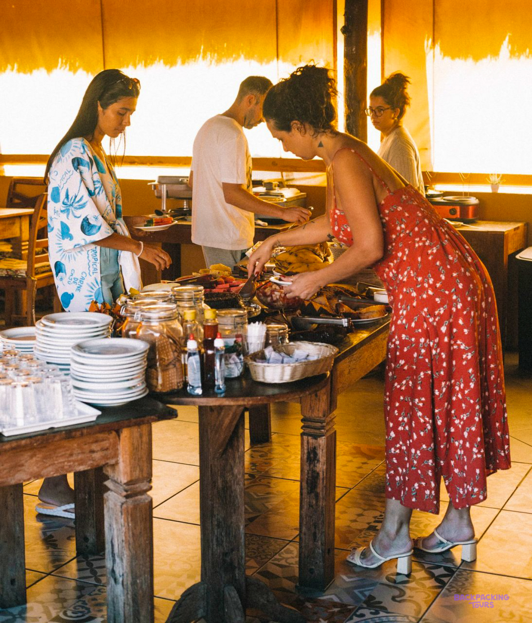 Travellers helping themselves to breakfast at the pousada on Ilha Grande