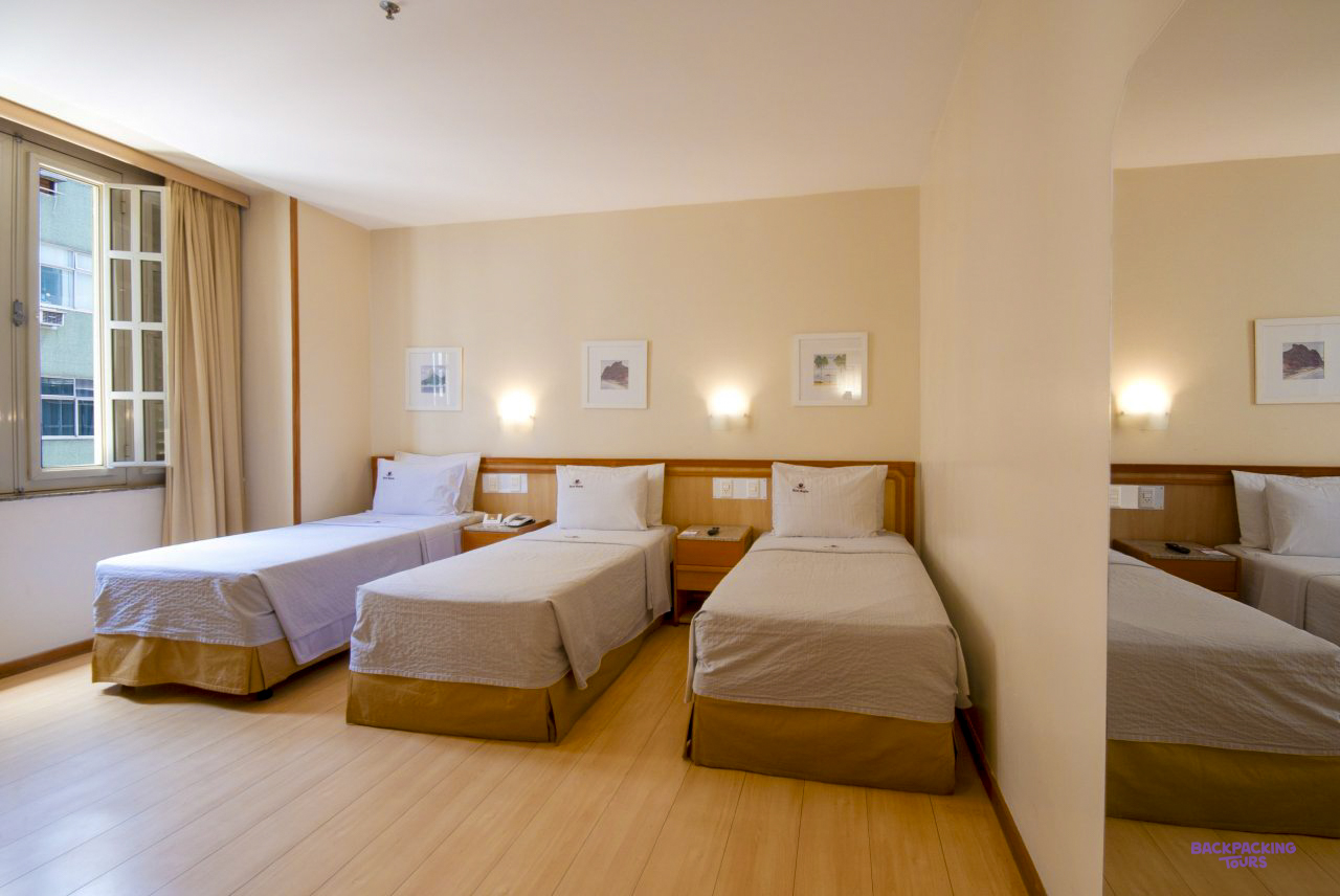 A room with three single beds at the hotel in Rio de Janeiro