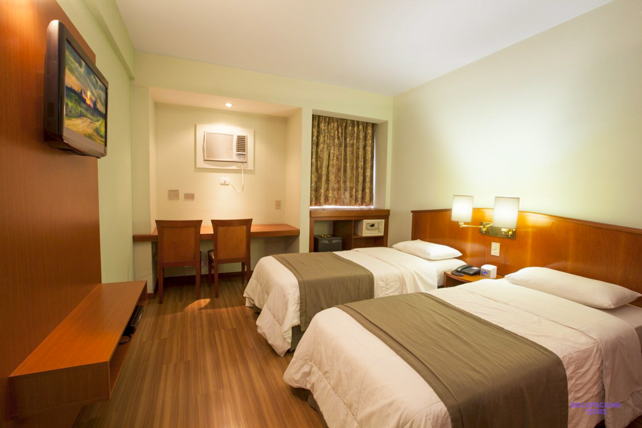 A twin room with wooden furniture at the hotel in São Paulo