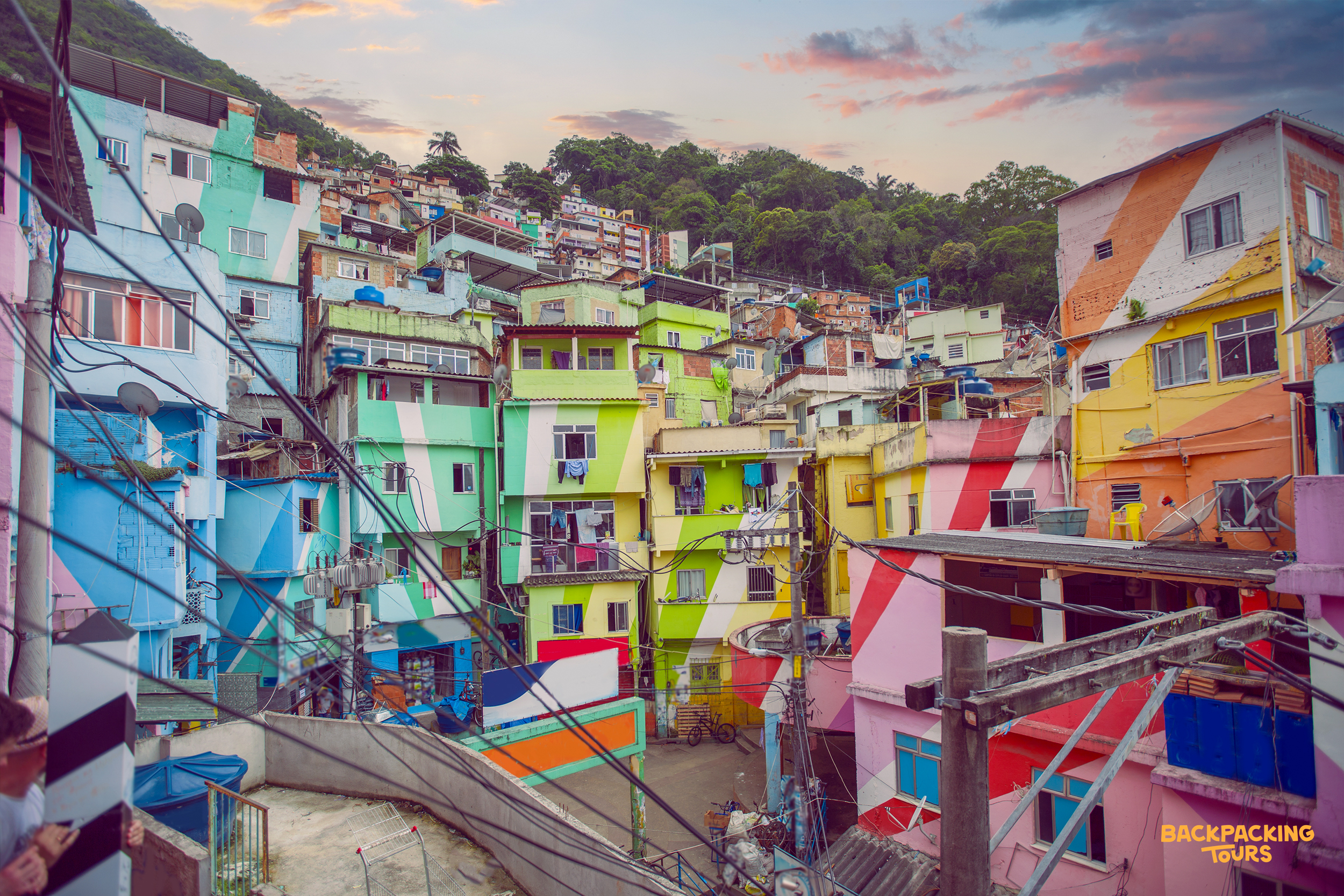 Vibrantly painted houses with geometric patterns cover a hillside favela in Rio de Janeiro.