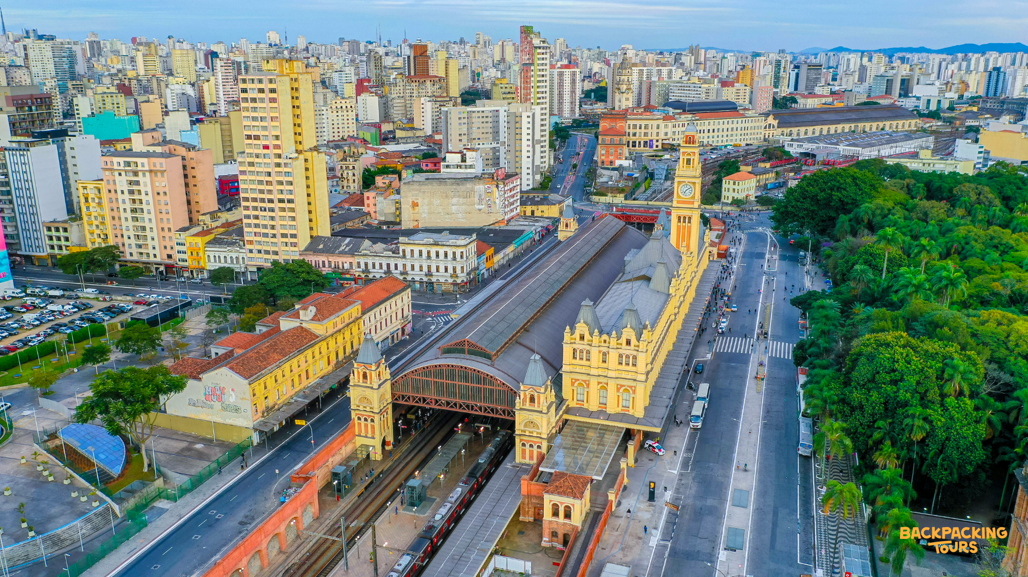 An aerial view captures the historic Estação da Luz train station amidst the sprawling city of Sao Paulo.