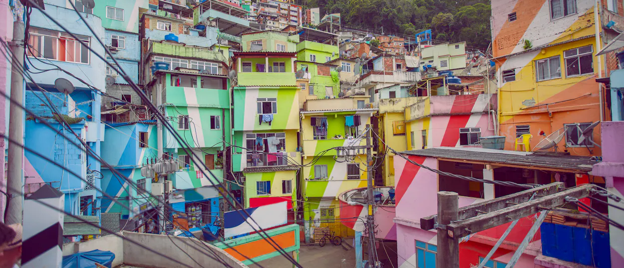 A vibrant favela in Rio de Janeiro, Brazil, with colorful houses and intricate electrical wiring.