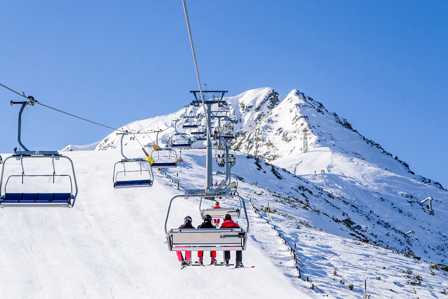 Ski lift climbing over the snowy peaks of Bansko, Bulgaria