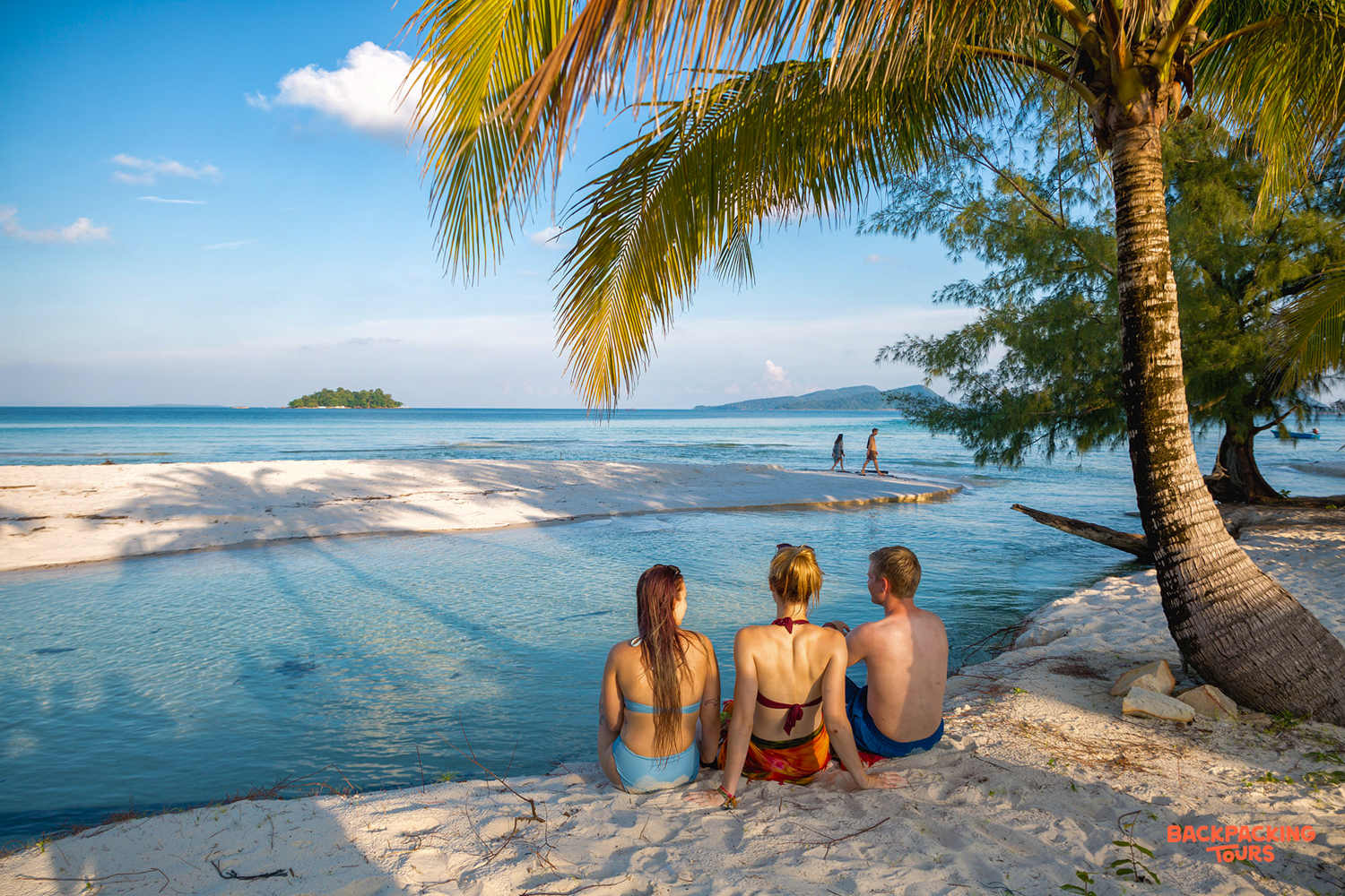 Friends enjoy a beautiful sunny day relaxing on the white sand beach in Koh Rong.