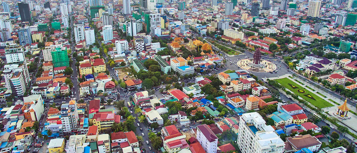 An aerial view of the bustling city of Phnom Penh with its diverse architecture and busy streets.