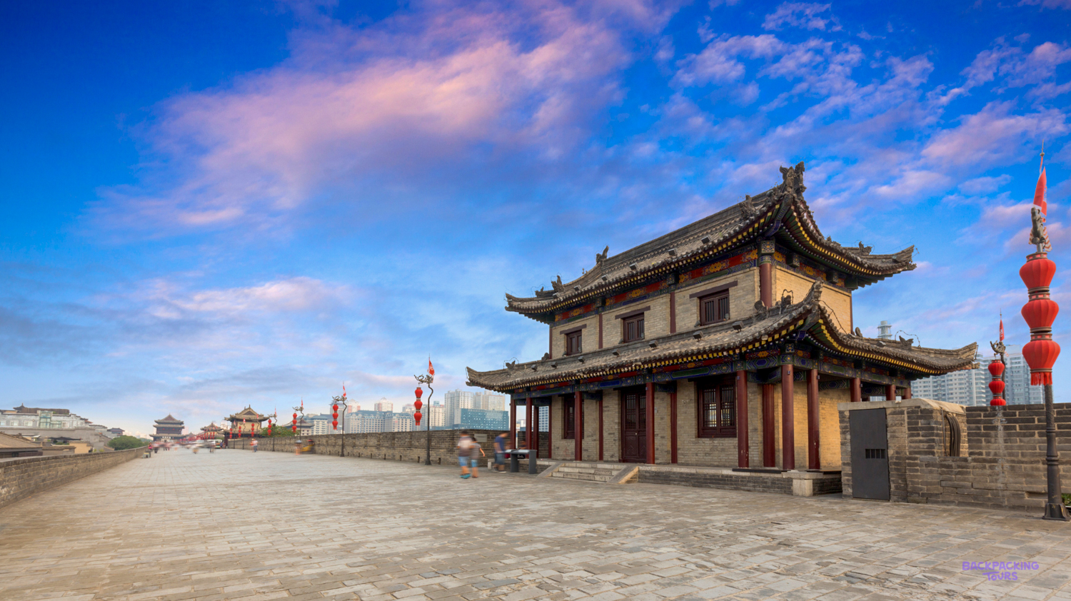 Traditional Chinese architecture on the historic Xi'an City Wall under a beautiful evening sky.