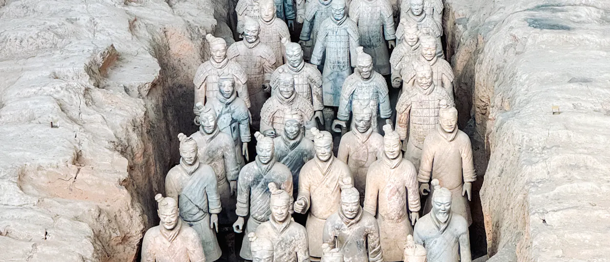Rows of ancient Terracotta Warriors standing in an excavated pit in Xi'an, China.