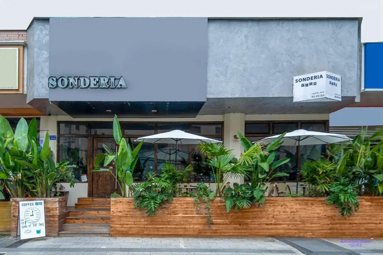 The front of the accommodation in Chengdu, with parasols and plants outside