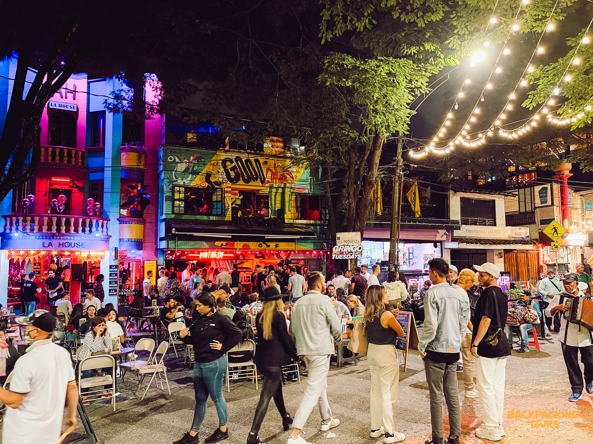 Medellín vibrant nightlife street scene with crowds