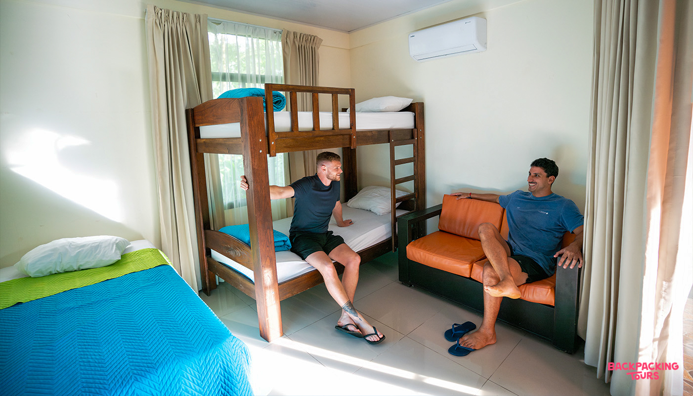 Friends relaxing in a shared dorm room after a day of exploring Costa Rica.