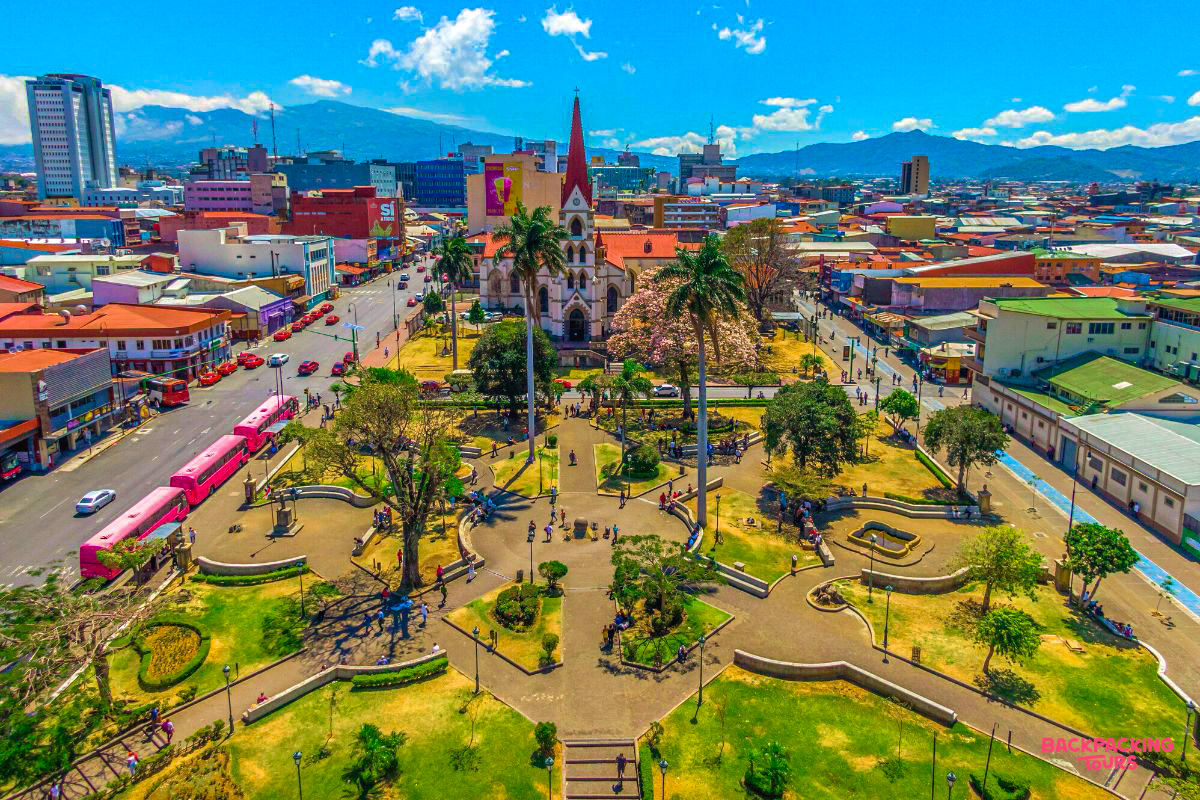 Overhead view of a lively city park and a beautiful church in San José, Costa Rica.