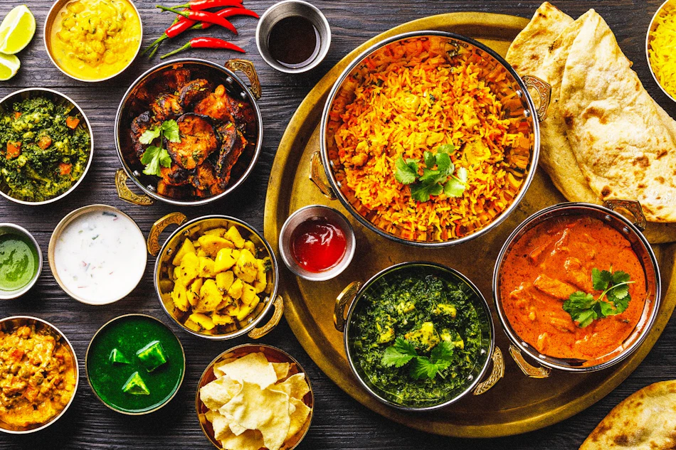 A spread of Indian dishes: curries, rice, breads and chutneys