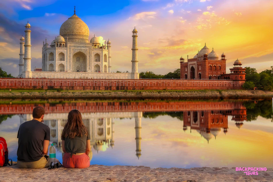 Two travellers watching sunrise at the Taj Mahal
