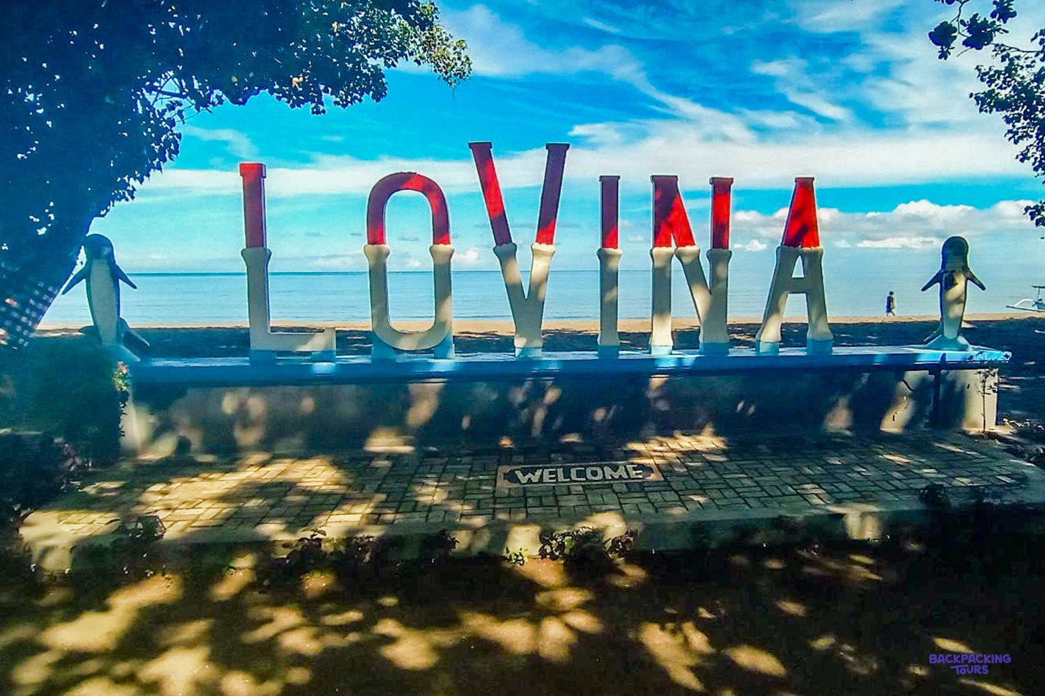 The giant red and white LOVINA letters on the seafront, with a dolphin statue either side.