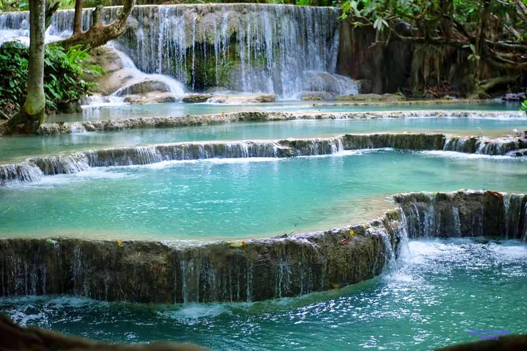 Turquoise pools step down a series of limestone terraces at the Kuang Si waterfalls near Luang Prabang.