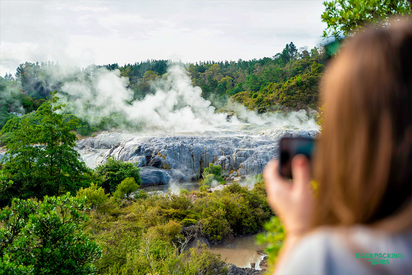 A backpacker captures the otherworldly steaming geothermal landscape in Rotorua, New Zealand.
