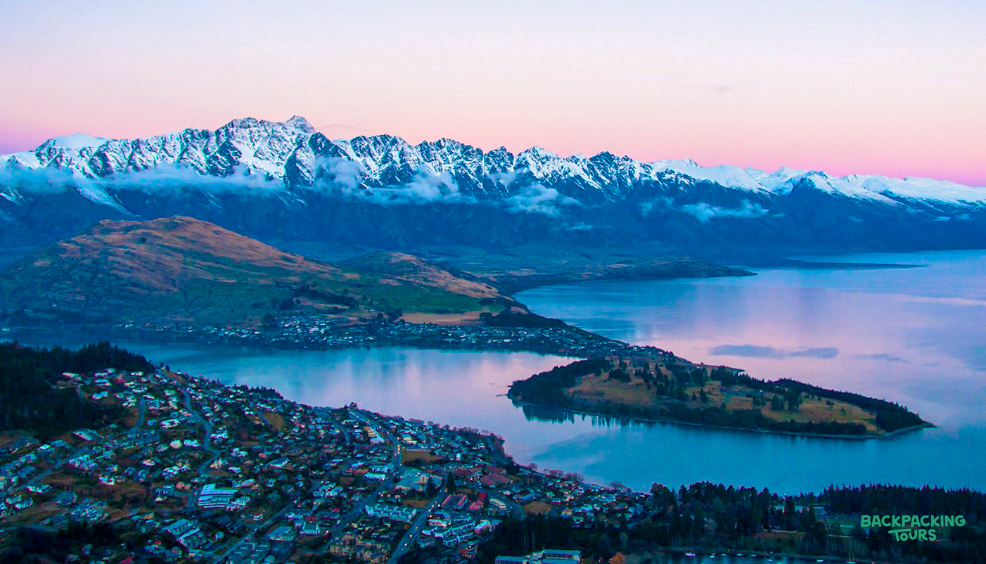 Beautiful sunrise over Queenstown, with Lake Wakatipu and the snow-capped Remarkables mountains.