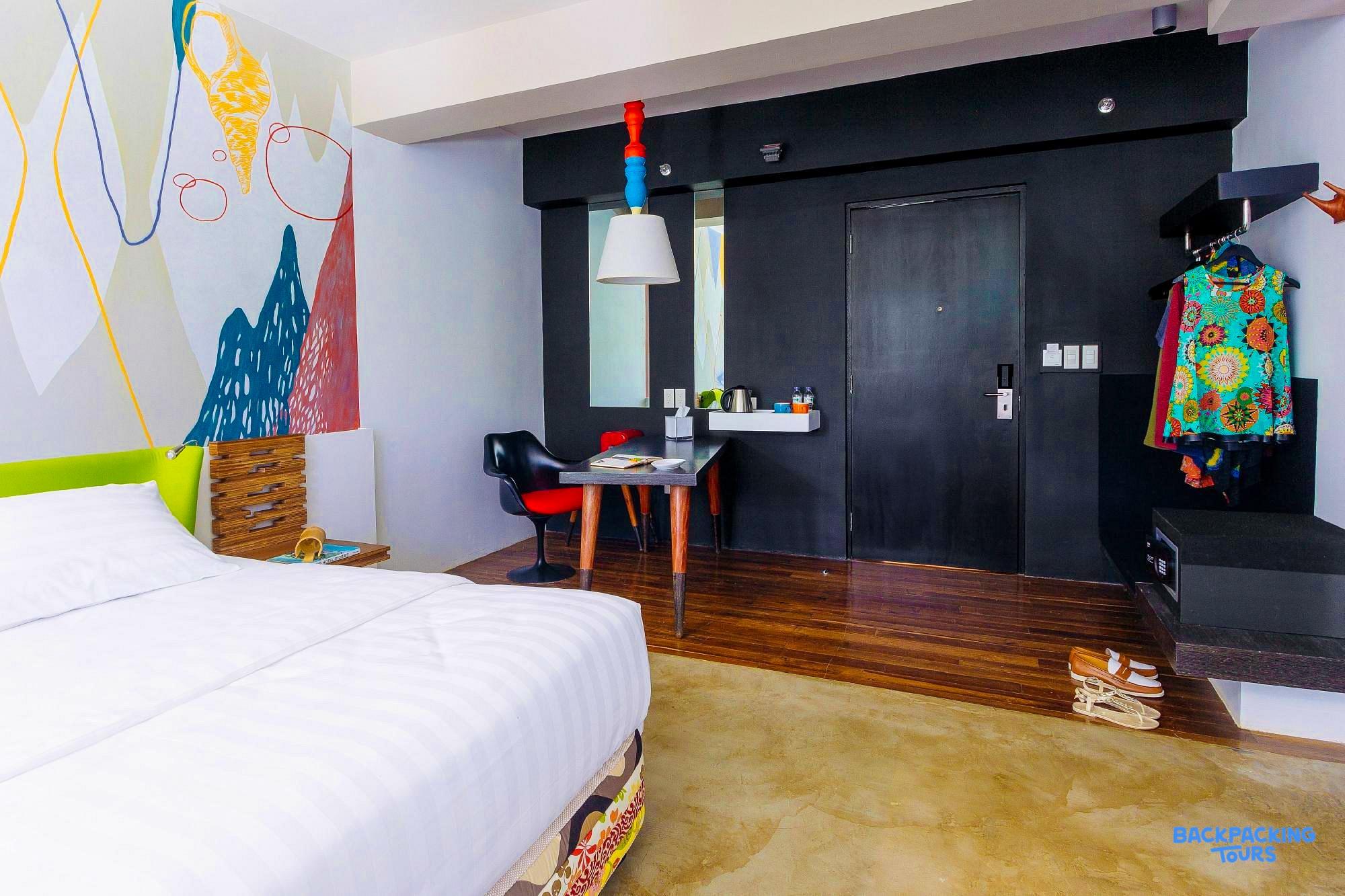 Bright and modern hotel room in Puerto Princesa, Philippines, with a comfortable bed and artistic decor.