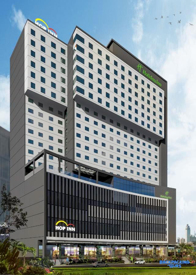 Exterior view of the modern Hop Inn and Holiday Inn hotels in bustling Cebu City.