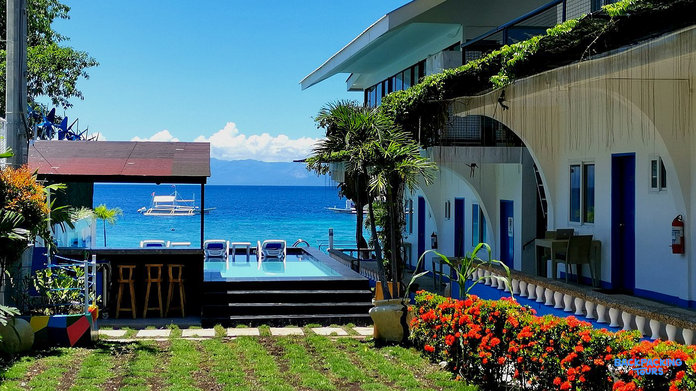 A tropical resort in Moalboal with a poolside bar and stunning views of the clear blue ocean.