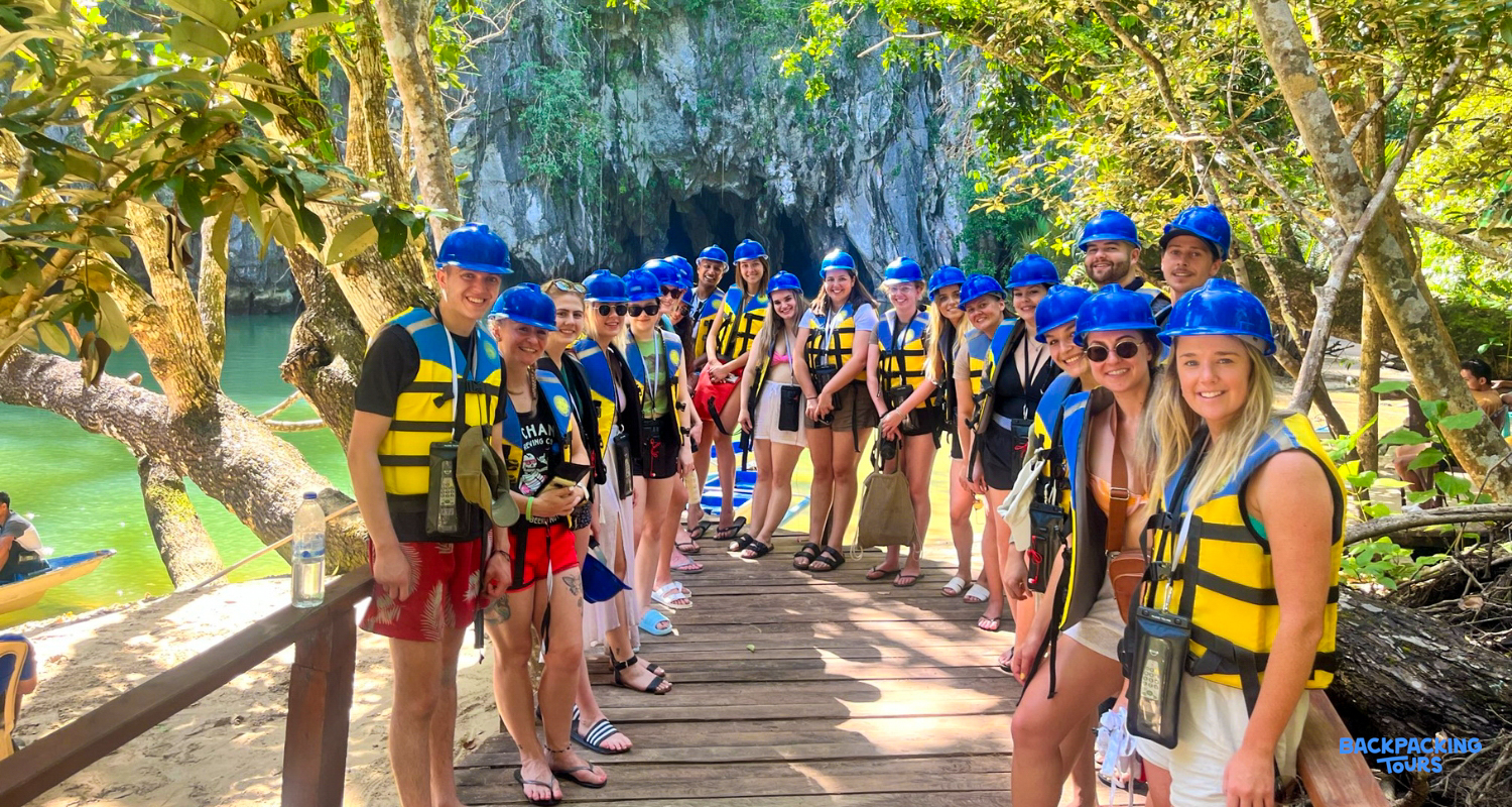 Happy backpackers in helmets and life vests ready to explore the Puerto Princesa Underground River.