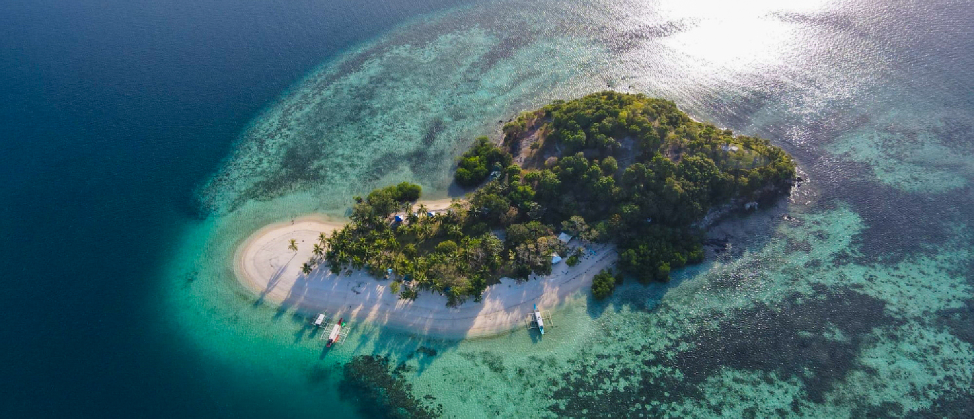 Aerial view of a tropical island with white sand beaches and clear turquoise waters, Coron, Philippines.