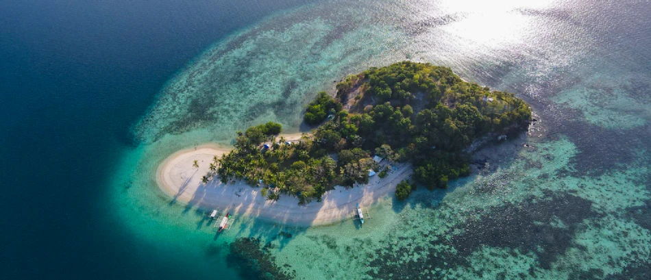 Aerial view of a tropical island with white sand beaches and clear turquoise waters, Coron, Philippines.