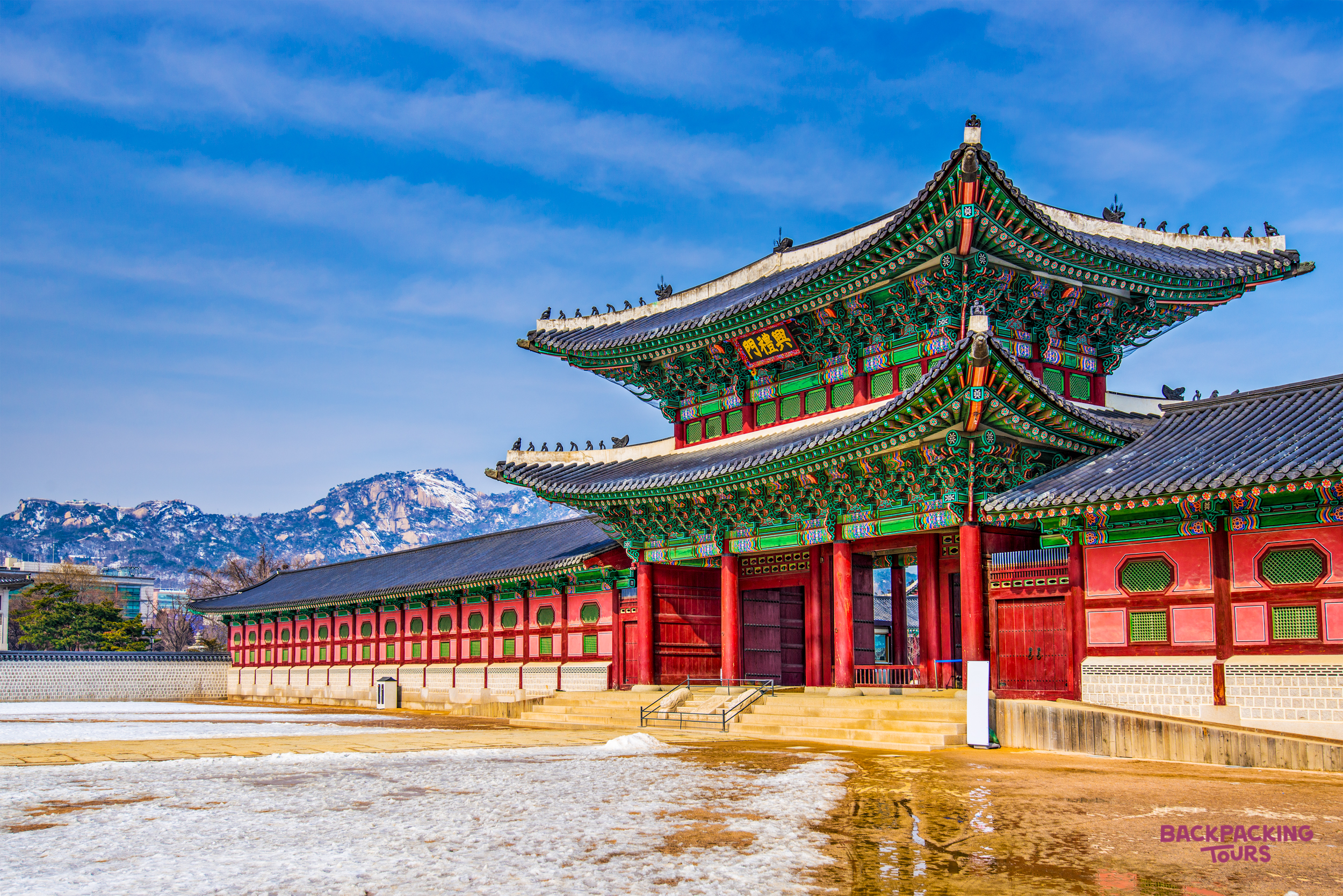 Grand Gyeongbokgung Palace in Seoul, showcasing traditional Korean architecture against a snowy landscape.