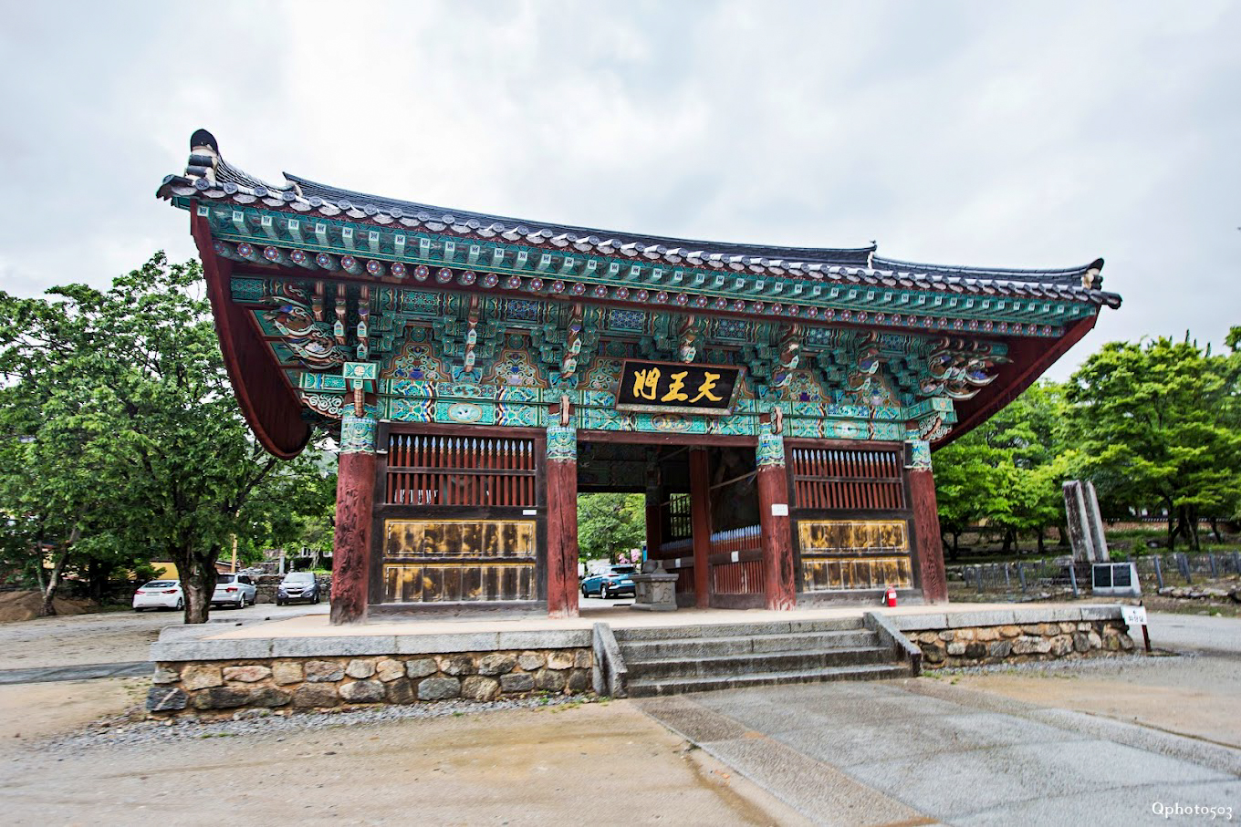 The vibrant, traditional entrance gate of Geumsunsa Temple, adorned with intricate Korean patterns.