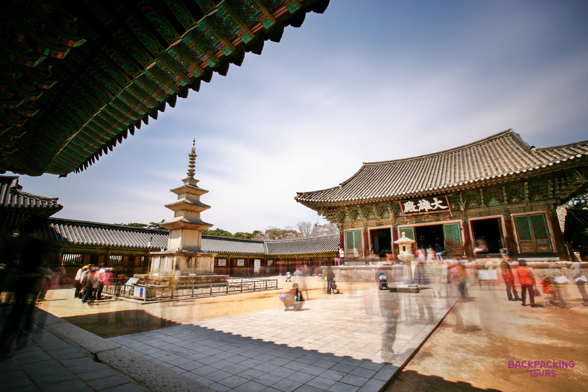 Visitors explore the serene grounds of Bulguksa Temple in Gyeongju, admiring the ancient pagoda and traditional architecture.