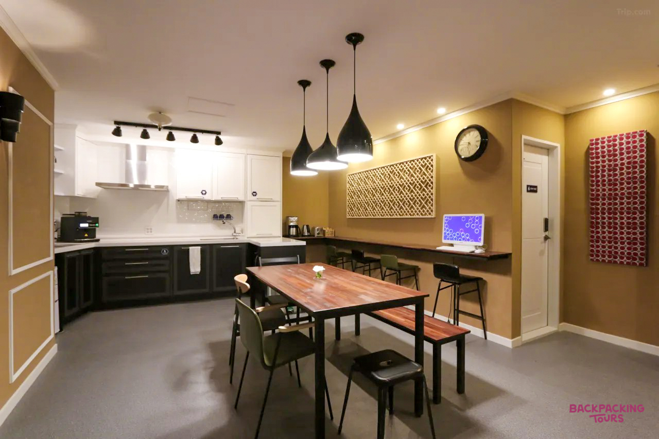 A modern and spacious common kitchen and dining area in a Gyeongju guesthouse, ready for travelers.